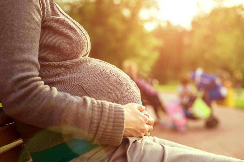 Pregnant woman sitting on a bench